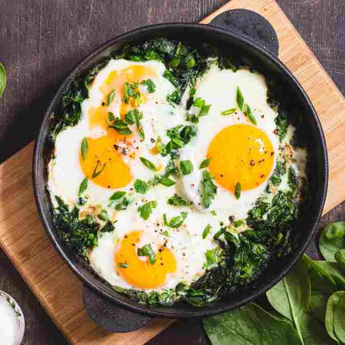 Easy Healthy Dinner Recipes UK: 8 Nutritious Weeknight Meals the Whole Family Will Love Egg and spinach shakshuka in a cast iron pan, a quick healthy dinner recipe ready in 20 minutes