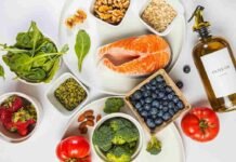 Anti-Inflammatory Foods: What to Eat to Help Your Body Heal Flat lay of the best anti-inflammatory foods including salmon, berries, walnuts, spinach and turmeric on a marble surface