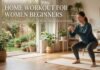 The Best Home Workout for Women Beginners: A Realistic 4-Week Plan That Actually Works A woman performing a bodyweight squat on a yoga mat during a home workout for women beginners routine.