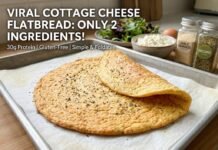 Cottage Cheese Flatbread Recipe: The Viral 2-Ingredient High-Protein Bake Cottage Cheese Flatbread Recipe: A freshly baked golden cottage cheese flatbread folded on parchment paper on a baking tray, surrounded by an egg, cottage cheese, and spice jars.