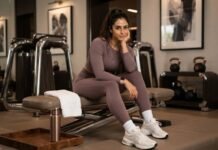 How to Build an Effortless Sports Luxe Wardrobe for Autumn 2026 sports luxe fashion trends: Woman in a matte sports luxe wardrobe co-ord by a bright window