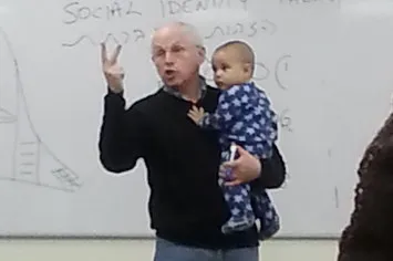 A photo of professor holding student’s baby goes viral