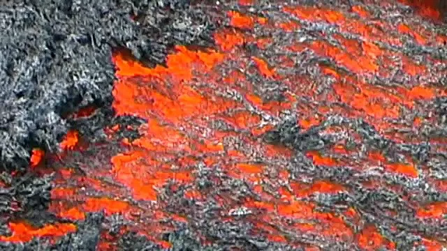 Lava run man runs over glowing lava flow on volcano Etna